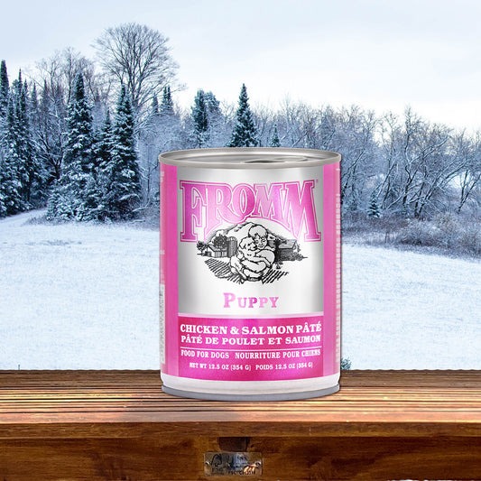 Fromm Classic Puppy Chicken & Salmon Pâté can on a wooden ledge in front of a snowy landscape