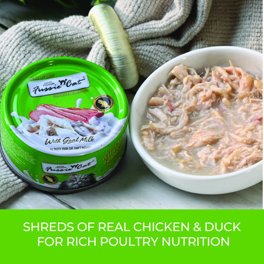Fussie Cat Chicken with Duck in Goat Milk Gravy can beside a white bowl of shredded chicken and duck in gravy