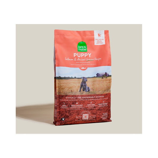 Open Farm Puppy Salmon and Ancient Grains Recipe bag standing at an angle on a neutral surface