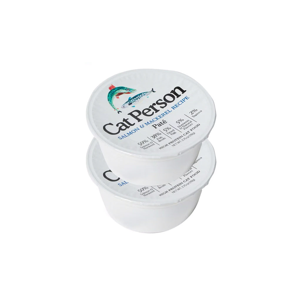 Two stacked white tubs of Cat Person Salmon & Mackerel Recipe pâté wet cat food, with fish illustrations on the lids.