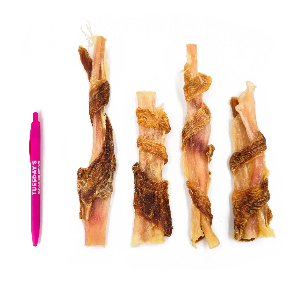 4 beef tendons wrapped in chicken next to a pen to show size. They are slightly larger than the pen.
