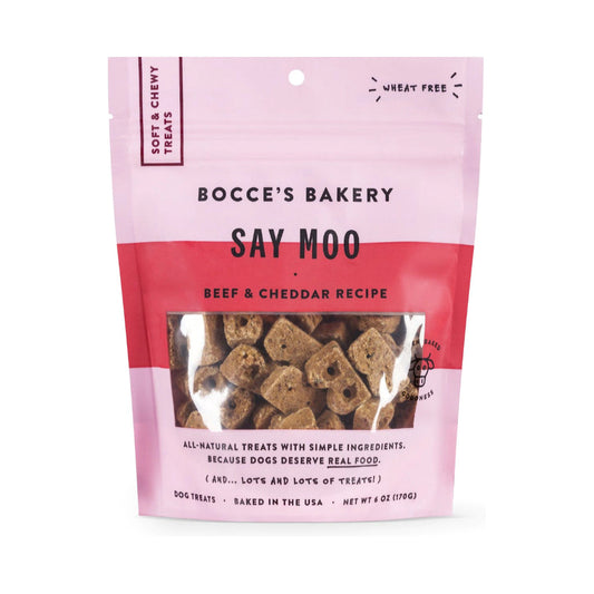 Front of a 6 oz pink pouch of Bocce’s Bakery Say Moo Beef & Cheddar soft and chewy dog treats, with treats visible through the window.