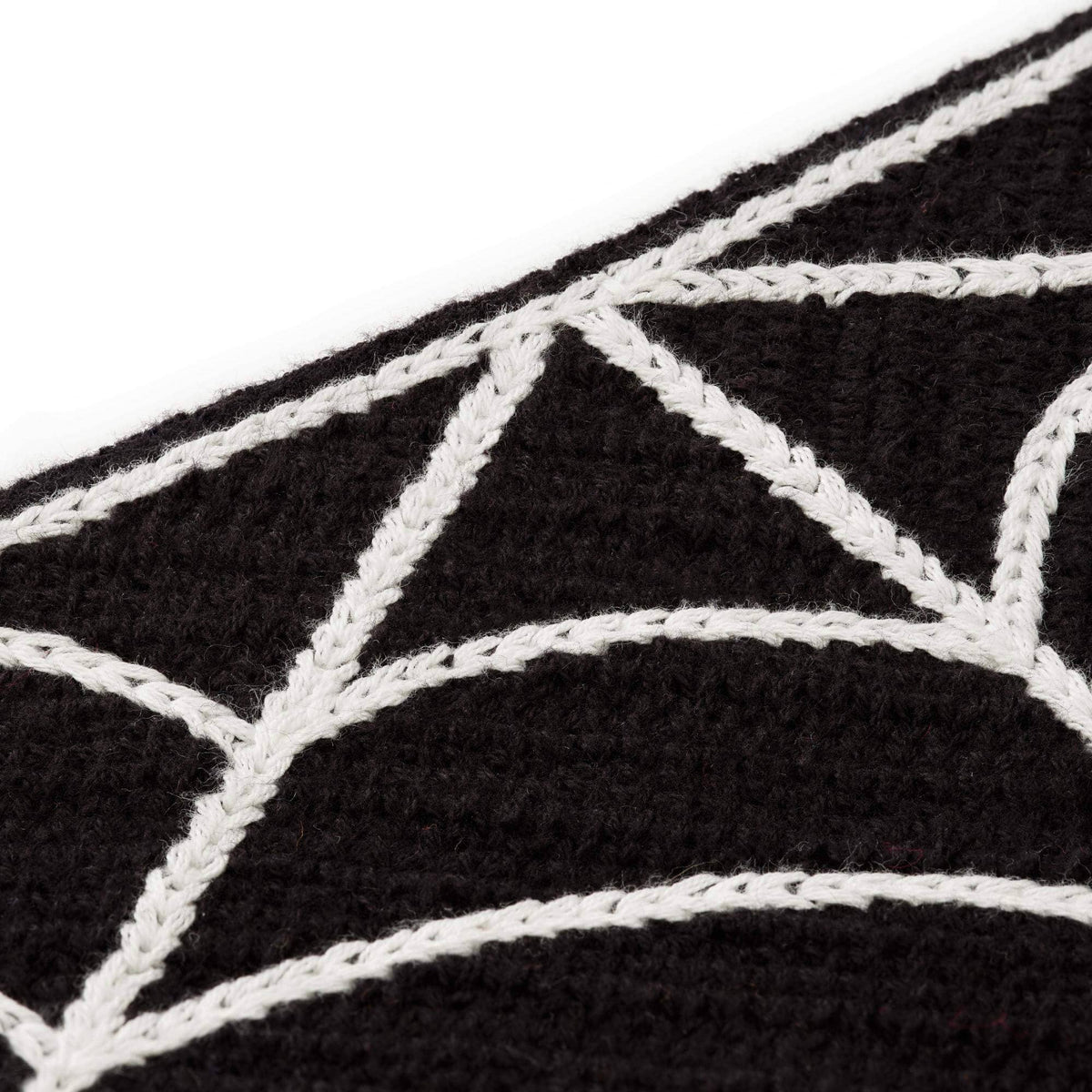 Fabric detail of The Foggy Dog Spiderweb Crochet bandana showing raised white web stitching on black crochet