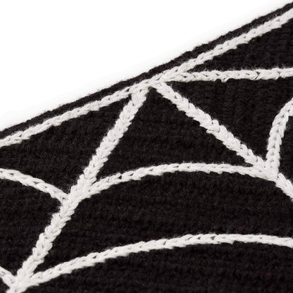 Fabric detail of The Foggy Dog Spiderweb Crochet bandana showing raised white web stitching on black crochet