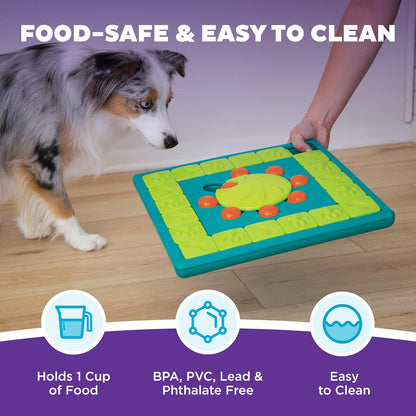 Person holding the MultiPuzzle beside a merle dog; infographic states one-cup food capacity, easy cleaning, and materials free of BPA, PVC, lead, and phthalates.