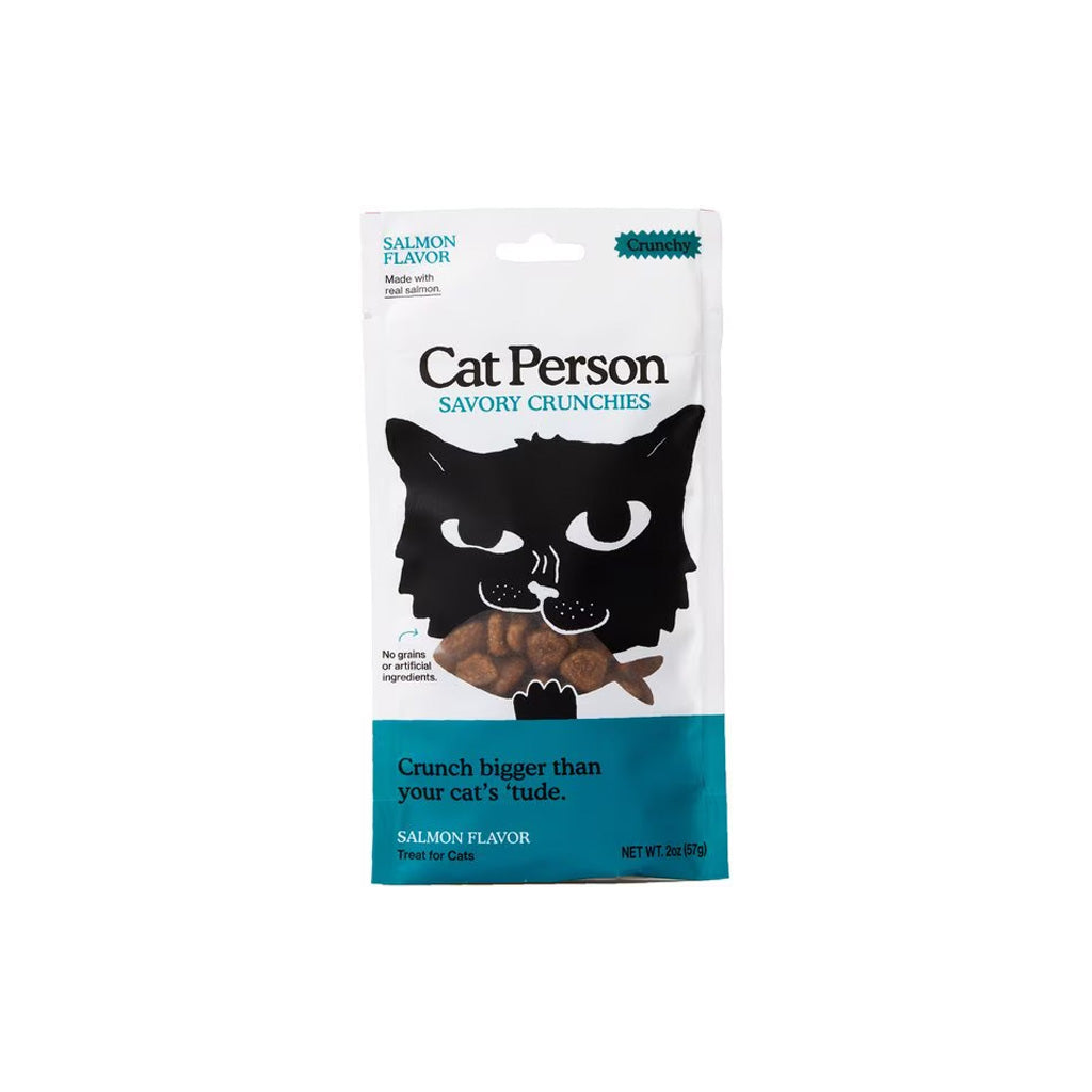 Front of a white and teal 2 oz Cat Person Salmon Flavor Savory Crunchies cat treat bag, with a black cat illustration and fish-shaped treats.