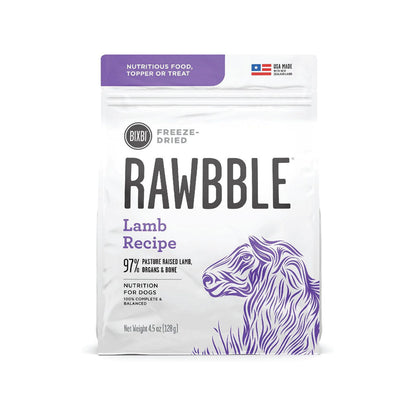 Front of a 4.5 oz bag of BIXBI RAWBBLE Lamb Recipe freeze-dried dog food, with purple lettering and a sheep illustration.