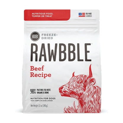 Front of a 12 oz bag of BIXBI RAWBBLE Beef Recipe freeze-dried dog food, with red lettering and a cattle illustration.