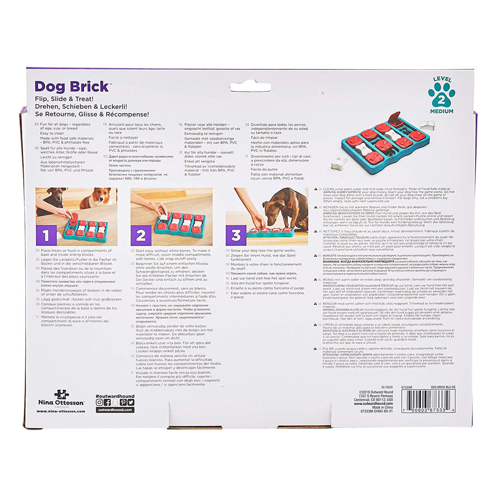 Back of Dog Brick packaging with illustrated steps for filling the treat compartments, closing the red lids, and letting the dog flip and slide pieces.