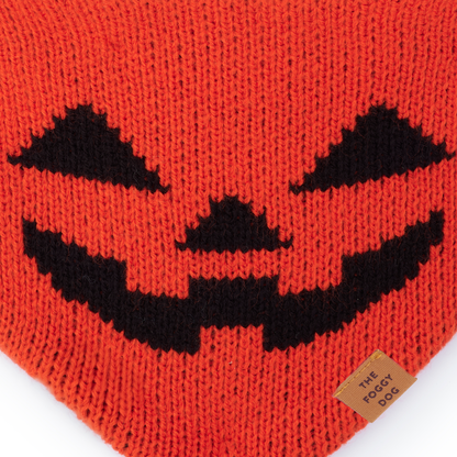 Close-up of the black pumpkin face knitted into The Foggy Dog orange Jack-o’-Lantern bandana