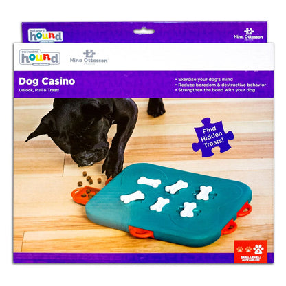 Nina Ottosson by Outward Hound Dog Casino Level 3 advanced puzzle packaging, showing a turquoise game with white bone locks and red treat drawers.