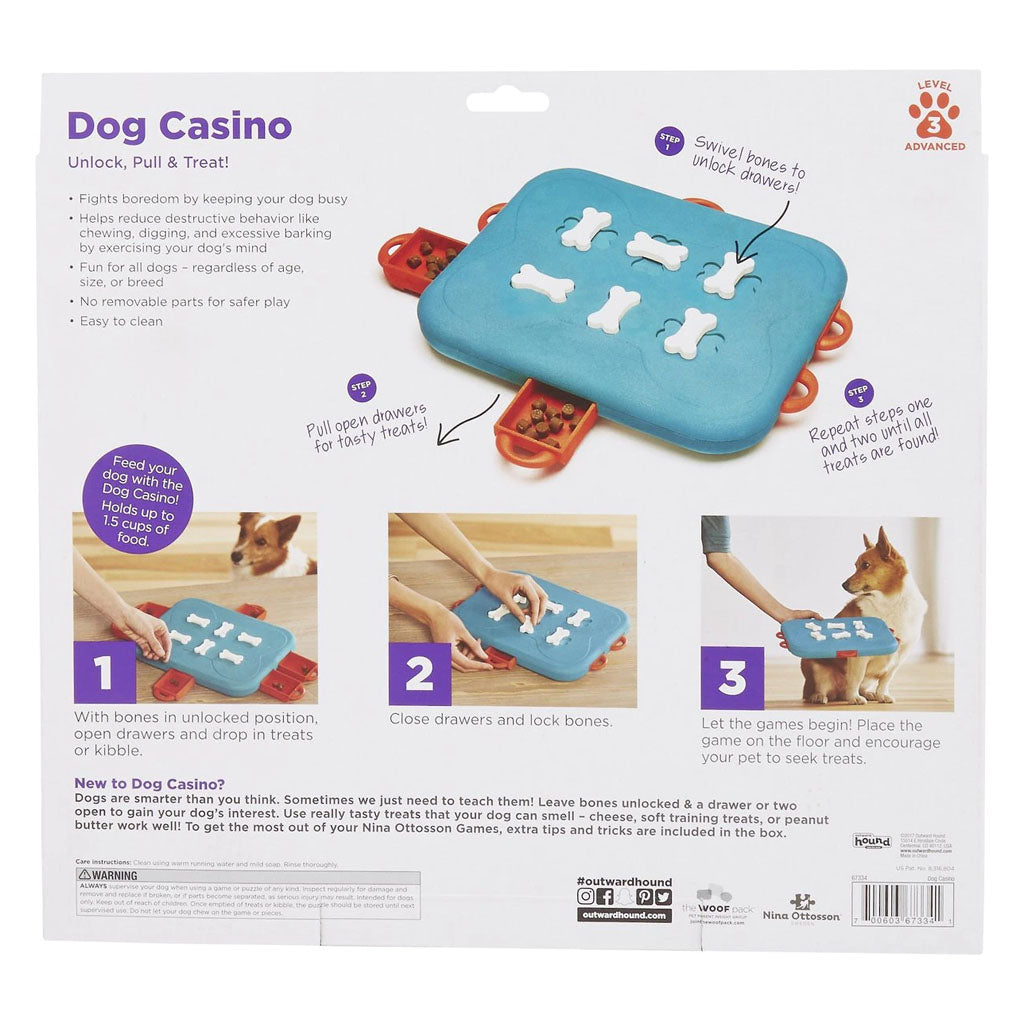 Back of Dog Casino packaging showing how to fill the red drawers, turn the white bone locks, and let the dog uncover the treats.