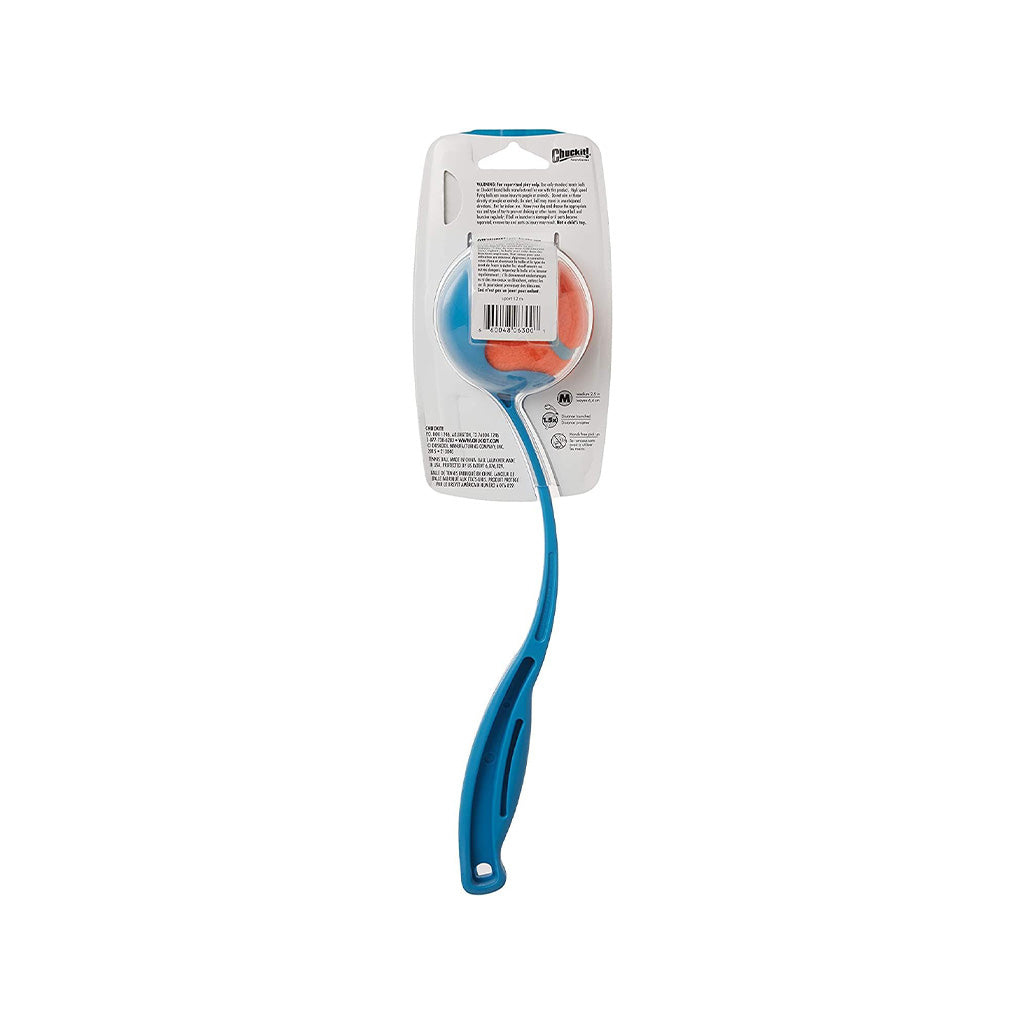 Rear view of a packaged compact blue Chuckit! ball launcher, showing its curved handle, included tennis ball, and package instructions.