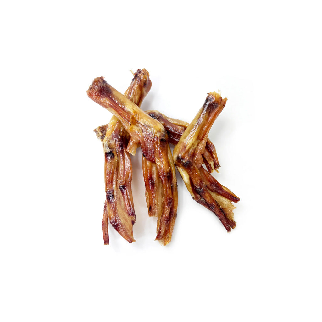 Barkworthies baked duck feet dog chews arranged on a white background.