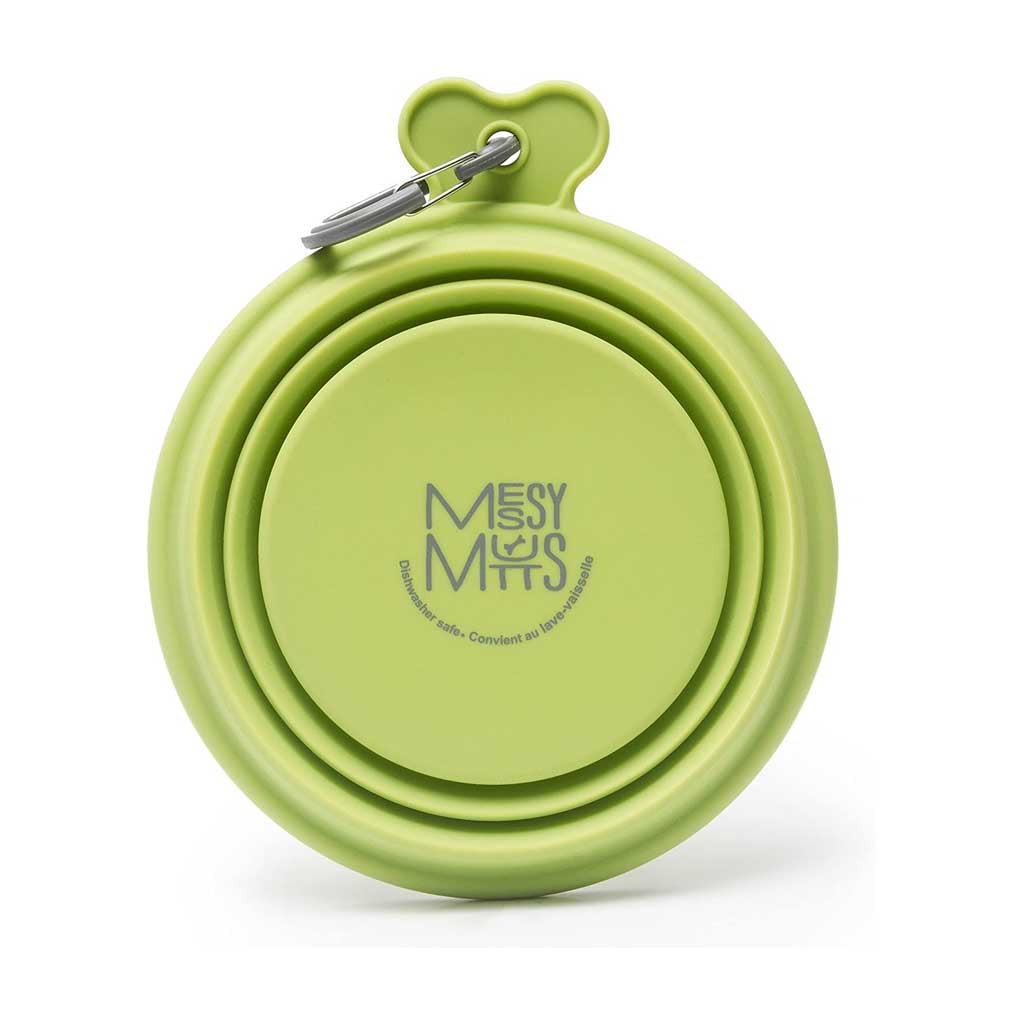 Green Messy Mutts silicone travel bowl folded flat, showing its logo and attached gray carabiner.