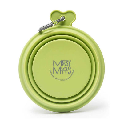 Green Messy Mutts silicone travel bowl folded flat, showing its logo and attached gray carabiner.