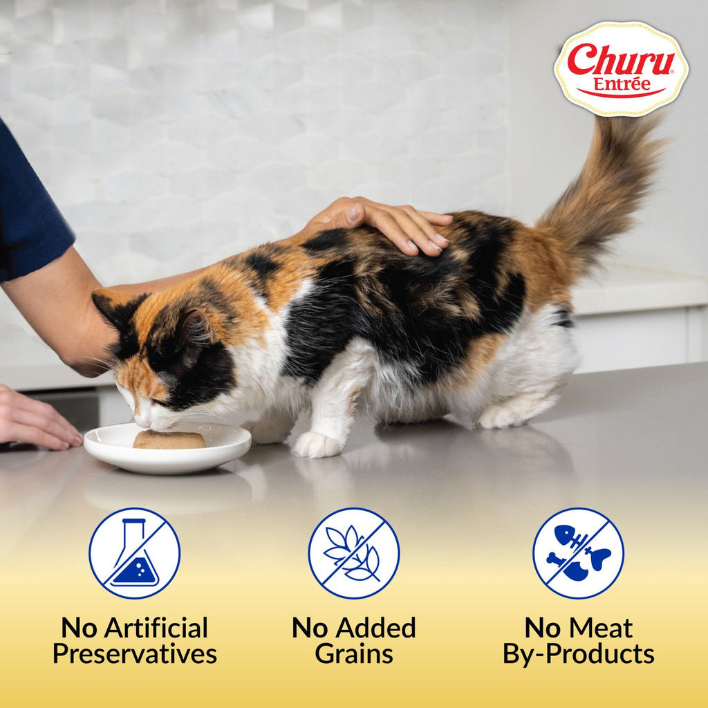 Cat eating Inaba Churu Entrée with icons for no artificial preservatives, no added grains and no meat by-products