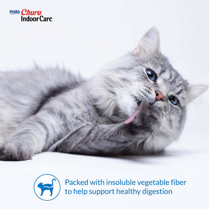 Gray cat grooming beside an Inaba Churu Indoor Care fiber and digestion support graphic