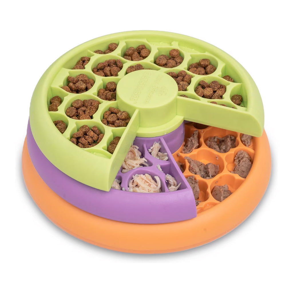 Catstages Lickin’ Layers cat puzzle feeder with rotating green, purple, and orange trays filled with kibble and wet food in textured compartments.