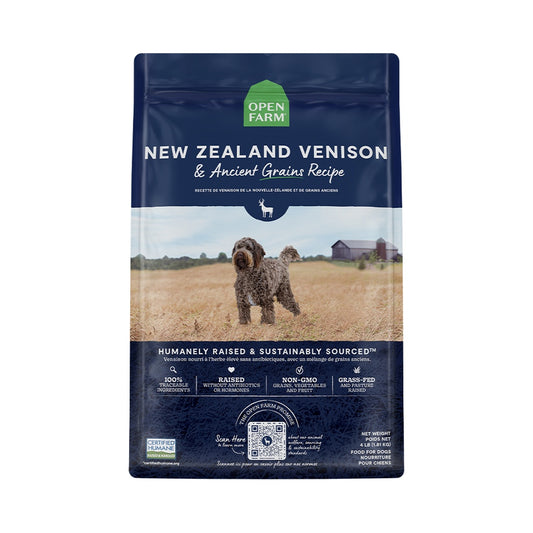 Front of navy Open Farm New Zealand Venison and Ancient Grains Recipe dry dog food bag with a dog pictured in a field