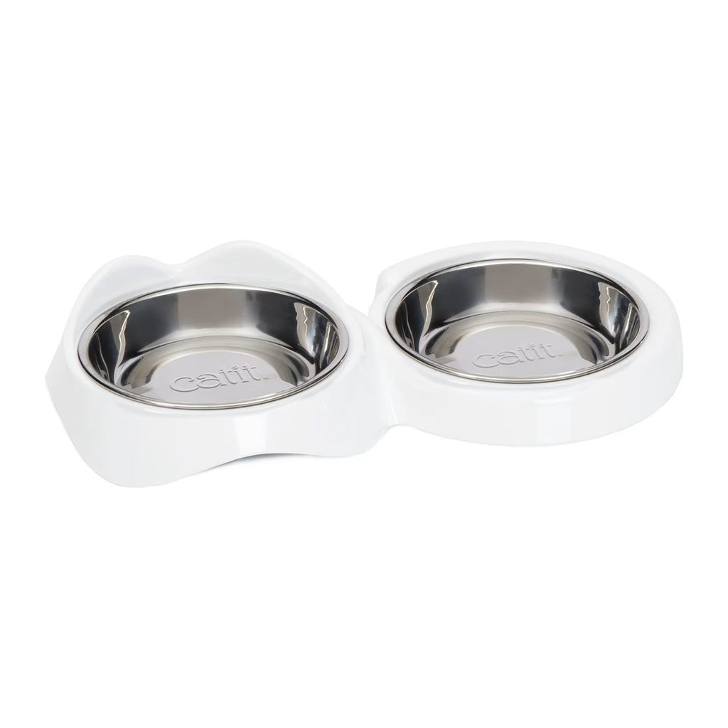 Catit PIXI double feeding dish with two stainless steel bowls in a white non-skid holder shaped with cat ears and a curved tail.