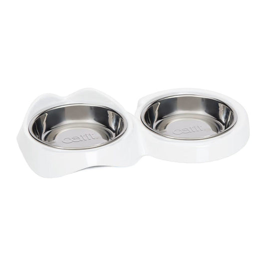 Catit PIXI double feeding dish with two stainless steel bowls in a white non-skid holder shaped with cat ears and a curved tail.