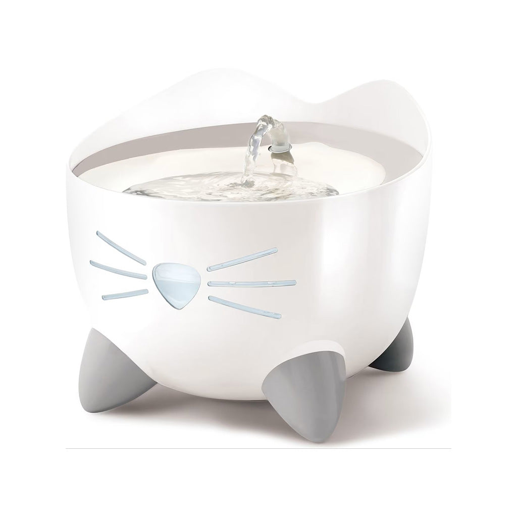 White Catit PIXI cat drinking fountain with flowing water, cat ears, a nose-and-whiskers water level window, and gray feet.