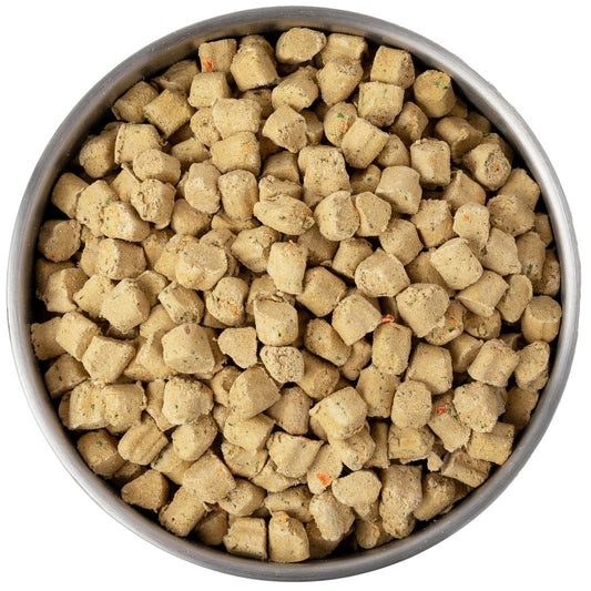 Overhead view of a metal bowl filled with Primal Kibble in the Raw freeze-dried dog food bites.