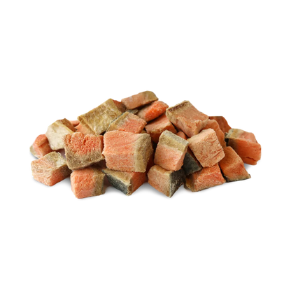 Pile of Vital Essentials freeze-dried diced salmon dog treat pieces on a white background