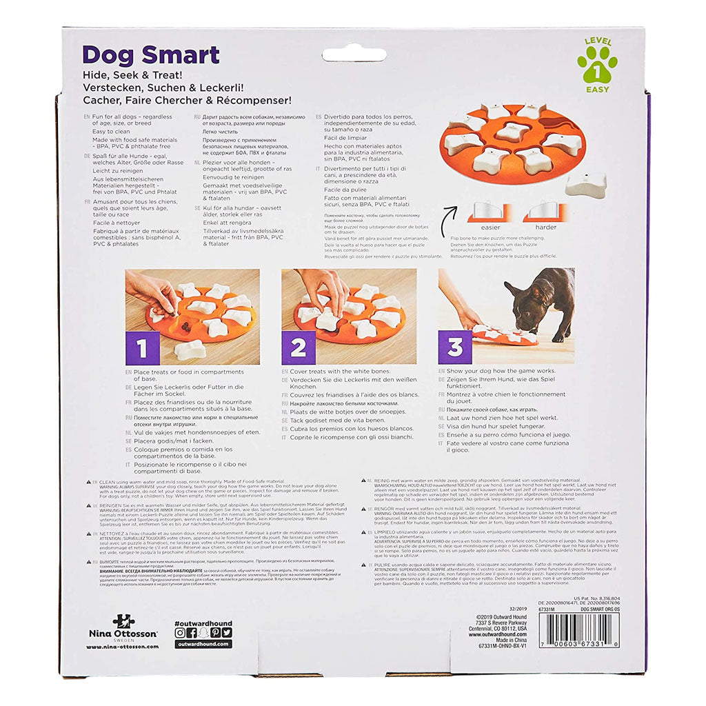 Back of Dog Smart packaging showing how to place treats in the orange tray, cover them with white bone pieces, and let the dog find them.