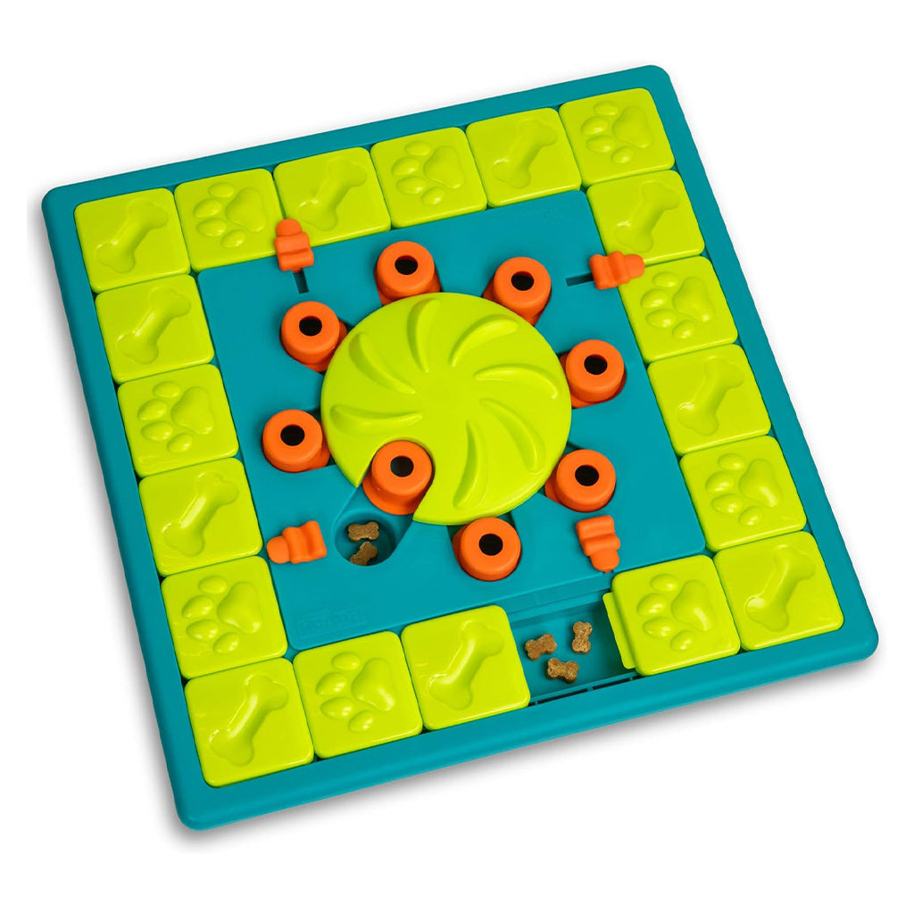 Nina Ottosson by Outward Hound MultiPuzzle dog toy with a turquoise base, green sliding tiles and spinning center, and orange treat covers.