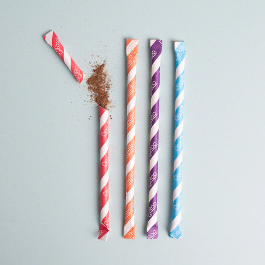 Four Dezi & Roo Silly Stix silvervine-filled paper straws in pink, orange, purple, and blue, with one opened to show the powder.