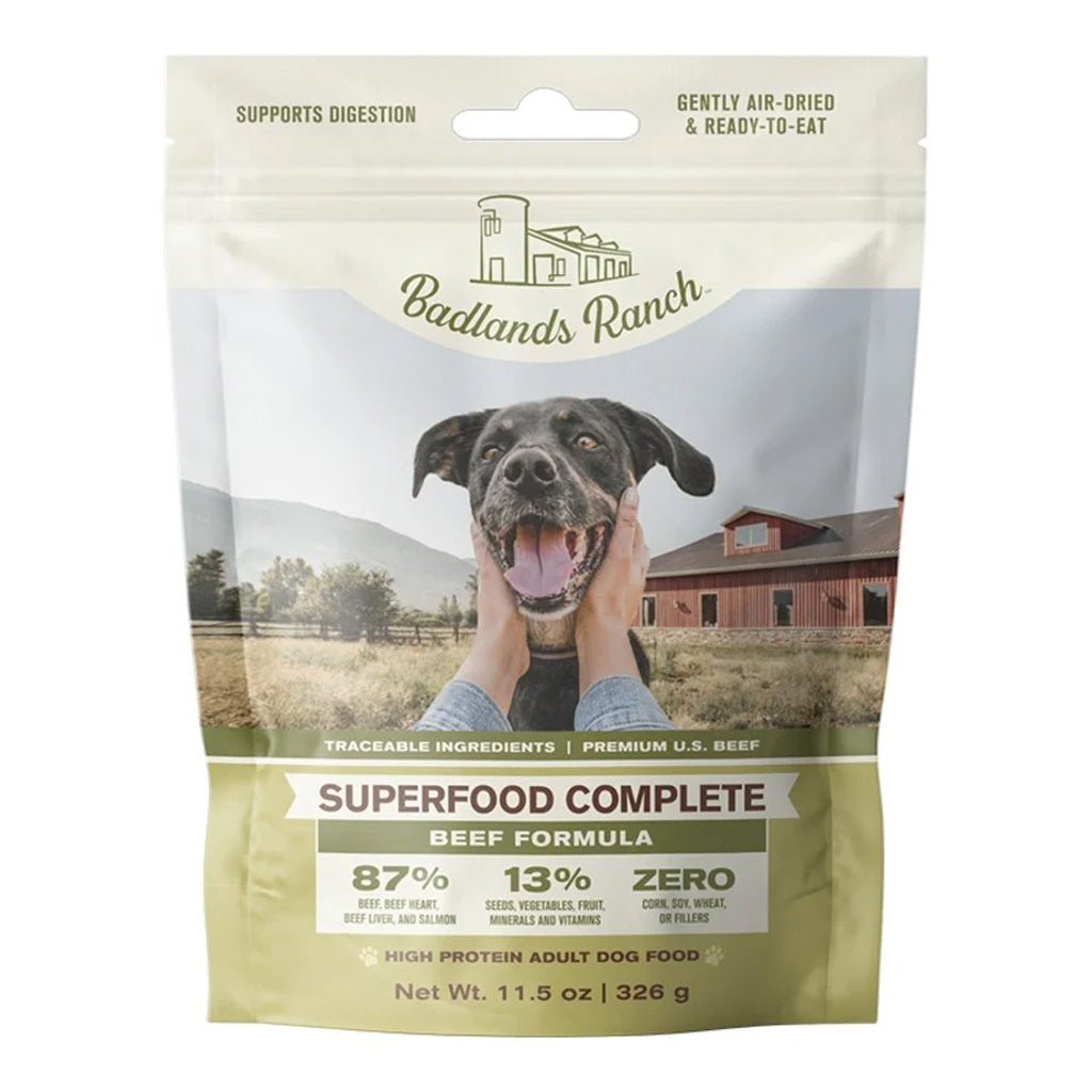 Front of Badlands Ranch Superfood Complete Beef Formula air-dried dog food pouch, with a green label and a black dog at a ranch.