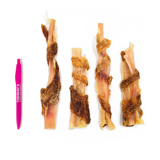 4 beef tendons wrapped in chicken next to a pen to show size. They are slightly larger than the pen.