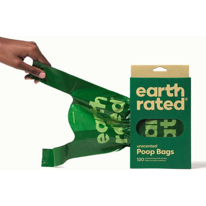 Hand pulling a green Earth Rated unscented poop bag with handles from its 120-count box