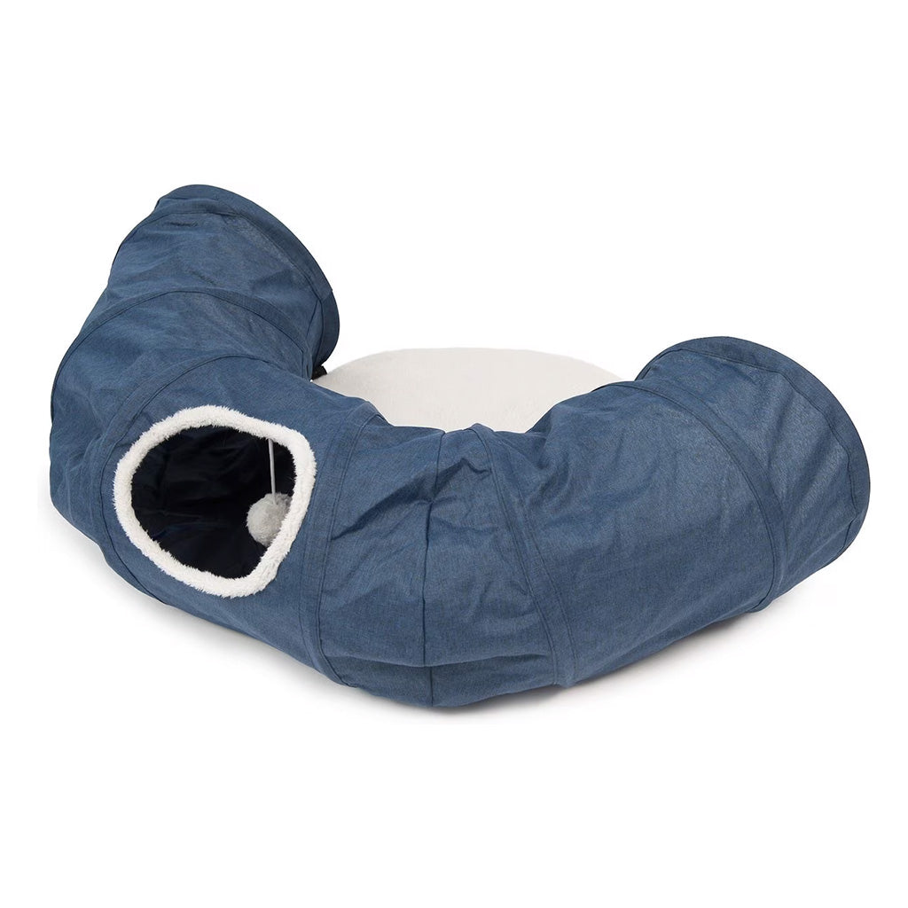 Blue Catit Vesper curved cat tunnel with a white-trimmed side opening, dangling plush ball, and cream center cushion.